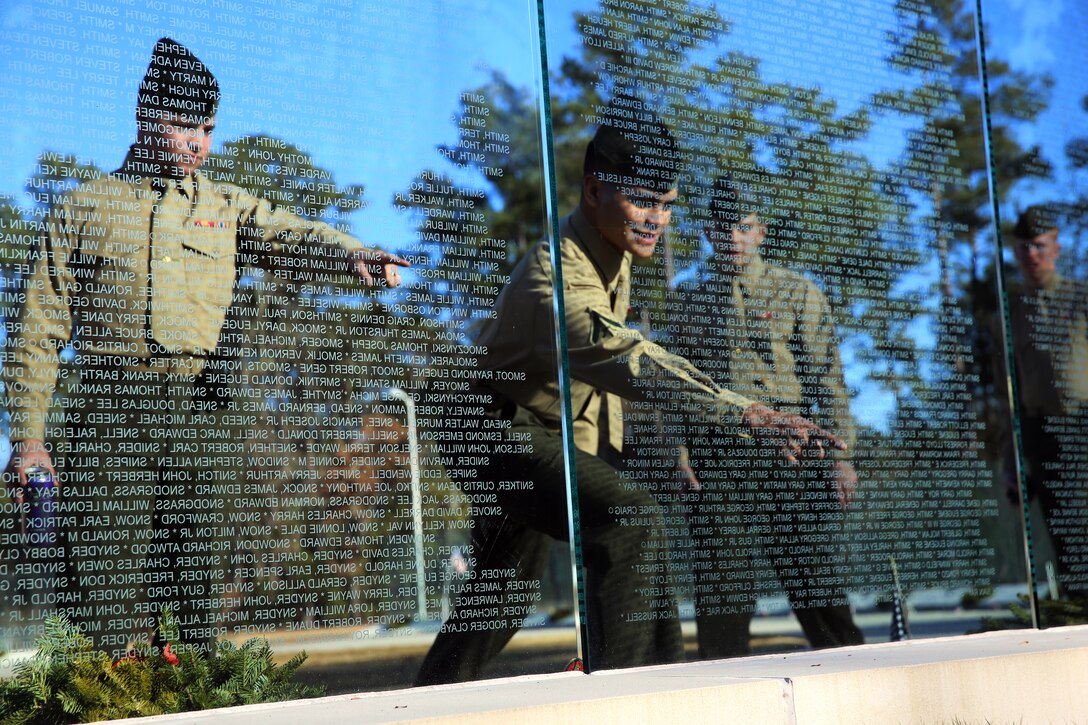 Pfc. Nathaniel Daniels, left, and Lance Cpl. Frank Smith IV, point out names at the Onslow County Vietnam Veterans Memorial, Jacksonville, N.C., Dec. 18, 2014. 
The Marines with Alpha Battery, 2nd Low Altitude Air Defense Battalion, visited the memorial to learn more about the Corps’ history and the sacrifice of previous generations of service members. Daniels, a native of Madison, Miss., and Smith, a native of Rush City, Minn., are both LAAD gunners with Alpha Battery.