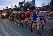 Tactical Air Control Party candidates pull a Humvee during the annual TACP Christmas PT session on Hurlburt Field, Fla., Dec 19, 2014. More than 100 Tactical Air Control Party candidates and cadre, dressed as elves, Santa and one as a fairy during the PT session. (U.S. Air Force photo/ Staff Sgt. Kentavist P. Brackin)