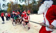 Tactical Air Control Party candidates face off against Santa and TACP instructors in a Tug-of-War competition during the annual TACP Christmas PT session on Hurlburt Field, Fla., Dec 19, 2014. More than 100 Tactical Air Control Party candidates and cadre, dressed as elves, Santa and one as a fairy during the PT session. (U.S. Air Force photo/ Staff Sgt. Kentavist P. Brackin)