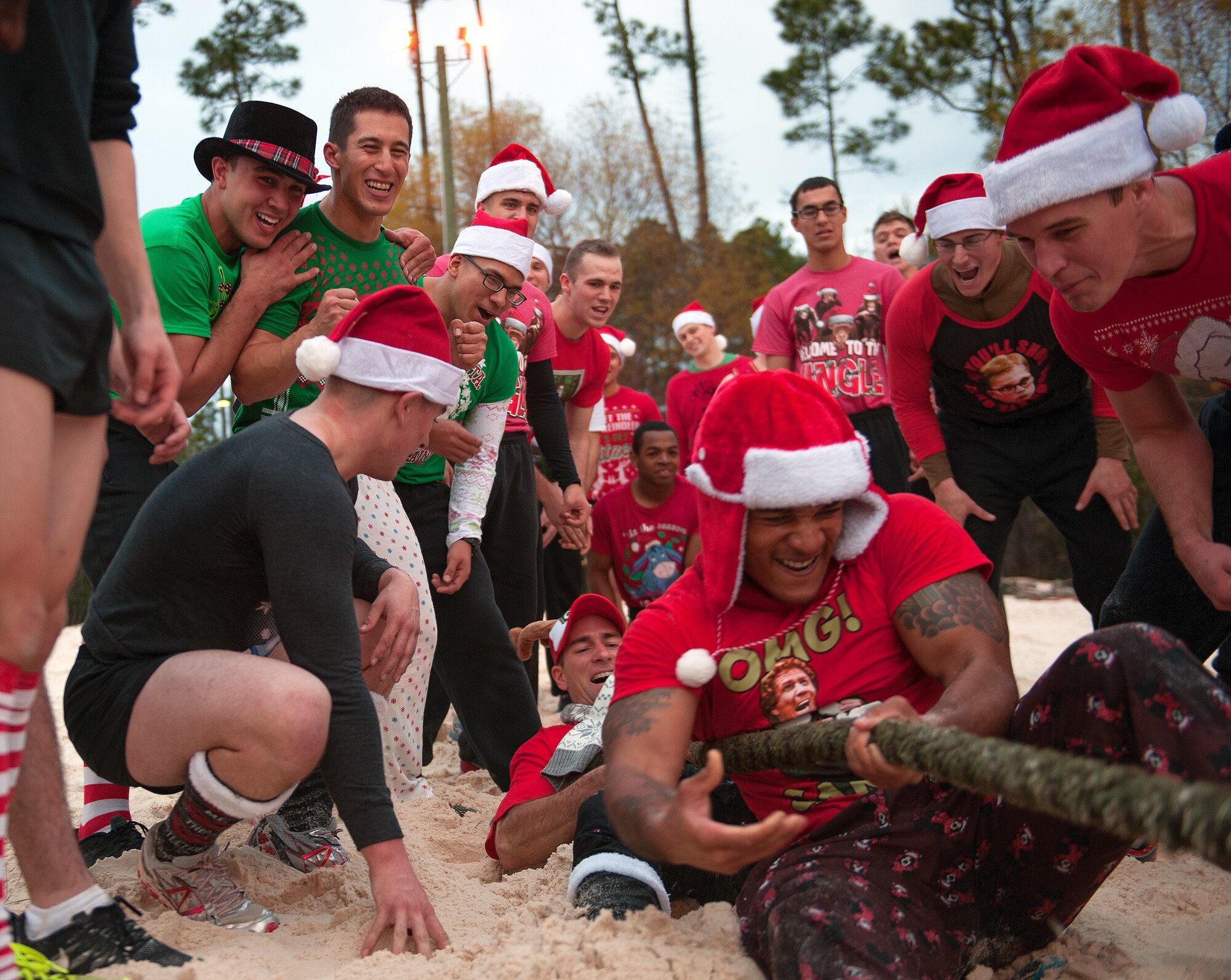 Tactical Air Control Party candidates cheer their team mates on during a tug-of-war competition at the annual TACP Christmas PT session on Hurlburt Field, Fla., Dec 19, 2014. Since the late 1990s, TACP candidates have participated in this holiday tradition to raise morale and camaraderie. (U.S. Air Force photo/ Staff Sgt. Kentavist P. Brackin)