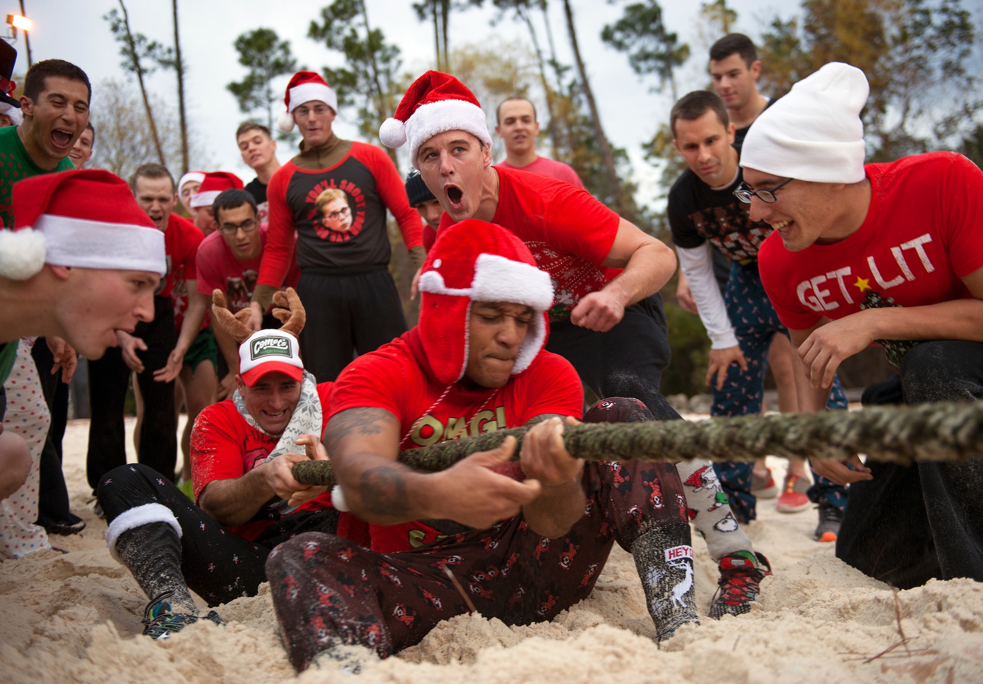 A Tactical Air Control Party candidate encourages his teammates during a Tug-of-War competition at the annual TACP Christmas PT session on Hurlburt Field, Fla., Dec 19, 2014. “The holiday PT session gives the Airmen a chance to come together and serves as a morale booster before the holidays,” said Master Sgt. Ernest Cecil, Detachment 3, 342nd Training Squadron apprentice course chief. (U.S. Air Force photo/ Staff Sgt. Kentavist P. Brackin)