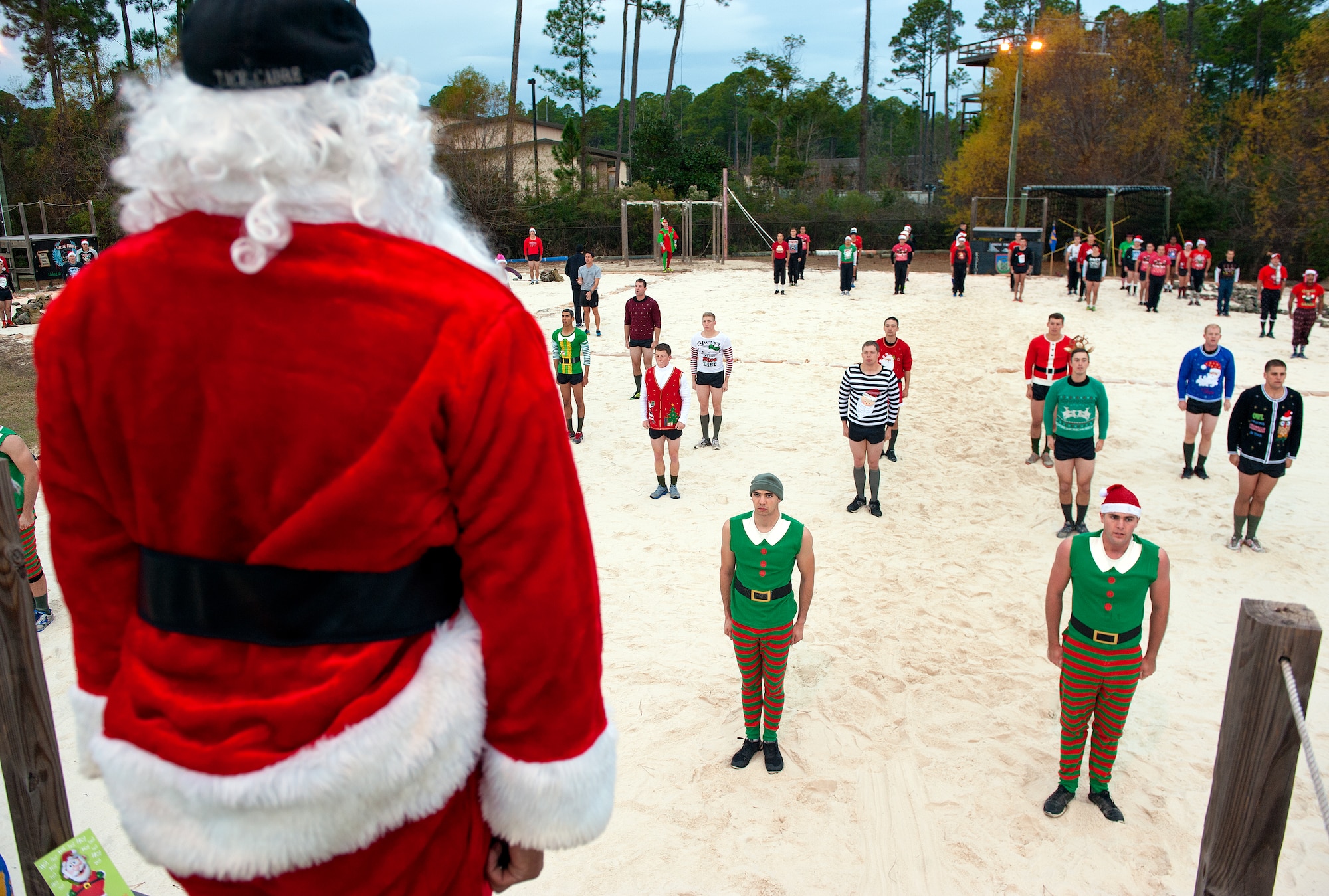 Tactical Air Control Party candidates cheer their team mates on during a tug-of-war competition at the annual TACP Christmas PT session on Hurlburt Field, Fla., Dec 19, 2014. Since the late 1990s, TACP candidates have participated in this holiday tradition to raise morale and camaraderie. (U.S. Air Force photo/ Staff Sgt. Kentavist P. Brackin)