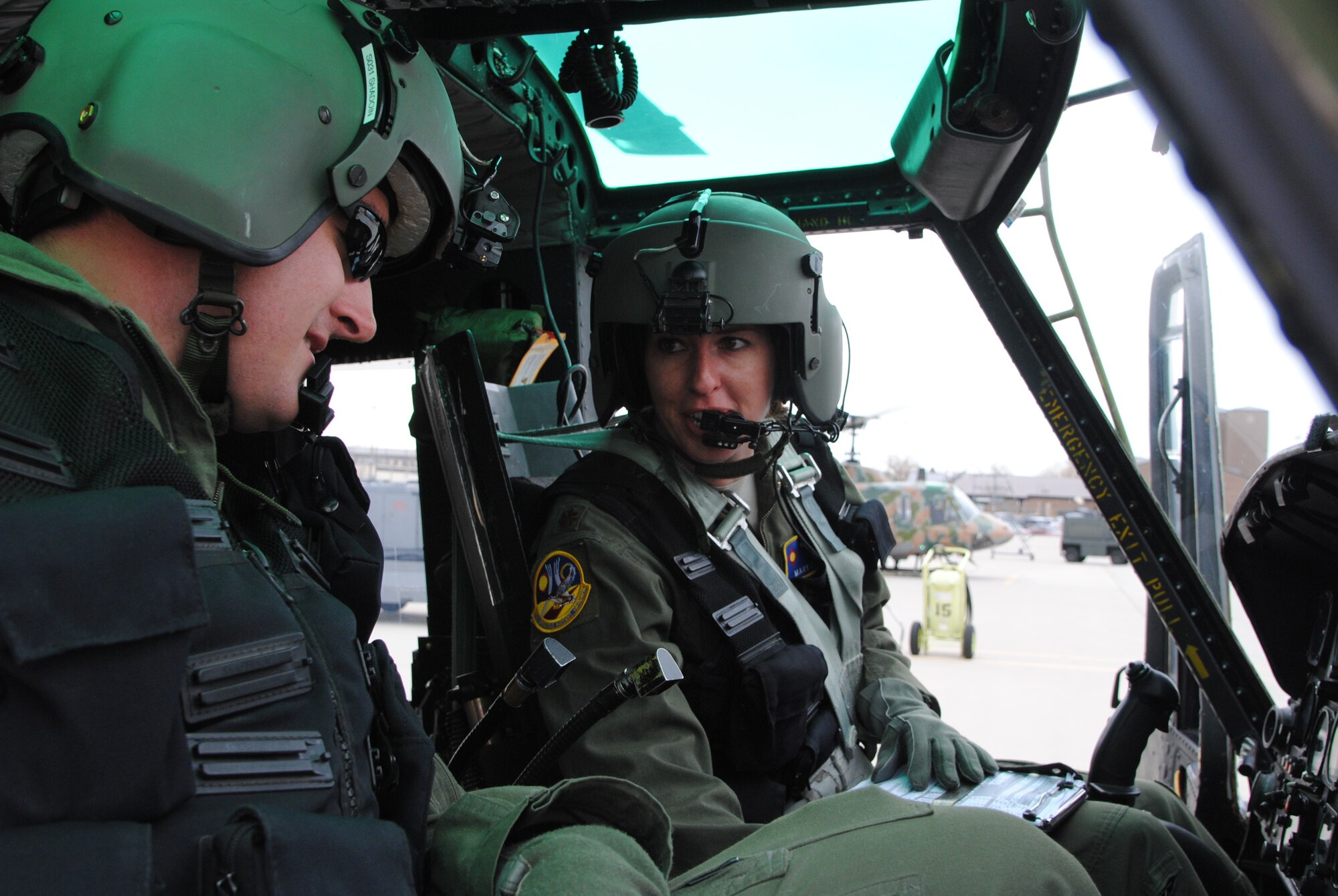 Maj. Mary Clark instructs 1st Lt. David Shadoin during pre-flight procedures Dec. 16, 2014, at Shindand Air Base, Afghanistan. Clark is an UH-1N Huey instructor pilot and the 58th Operations Support Squadron's assistant director of operations, and Shadoin a student pilot in the 512th Special Operations Squadron. (U.S. Air Force photo/Jim Fisher)
