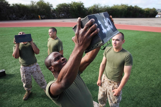 Private First Class Kanayochukwu Onyejeli, Platoon 3235, Kilo Company, 3rd Recruit Training Battalion, performs ammunition can lifts during the Combat Fitness Test at Marine Corps Recruit Depot San Diego, Dec. 22. The CFT is conducted in the Marine Corps Combat Utility Uniform and boots to simulate combat environments. There are three events in the CFT, each worth 100 points, leading to a perfect score of 300.