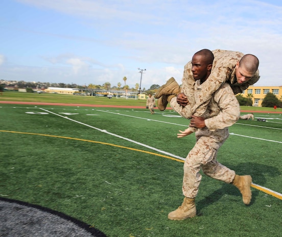 Private First Class Kanayochukwu Onyejeli, Platoon 3235, Kilo Company, 3rd Recruit Training Battalion, conducts the fireman carry during the maneuver under fire portion of the Combat Fitness Test at Marine Corps Recruit Depot San Diego, Calif., Dec. 22. The event consists of an 880-yard run, timed 30-pound ammunition can lifts and a maneuver under fire drill.