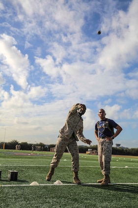 Private First Class Kanayochukwu Onyejeli, Platoon 3235, Kilo Company, 3rd Recruit Training Battalion, picks up a simulated grenade and throws it to a designated area approximately 22 yards away during the maneuver under fire portion of the Combat Fitness Test at Marine Corps Recruit Depot San Diego, Calif., Dec. 22. The CFT is a training requirement for all recruits as well as an annual requirement for all Marines.