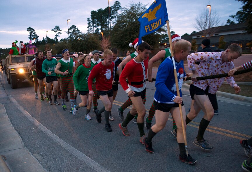 Tactical Air Control Party candidates pull a Humvee during the annual TACP Christmas PT session on Hurlburt Field, Fla., Dec 19, 2014. More than 100 Tactical Air Control Party candidates and cadre, dressed as elves, Santa and one as a fairy during the PT session. (U.S. Air Force photo/ Staff Sgt. Kentavist P. Brackin)