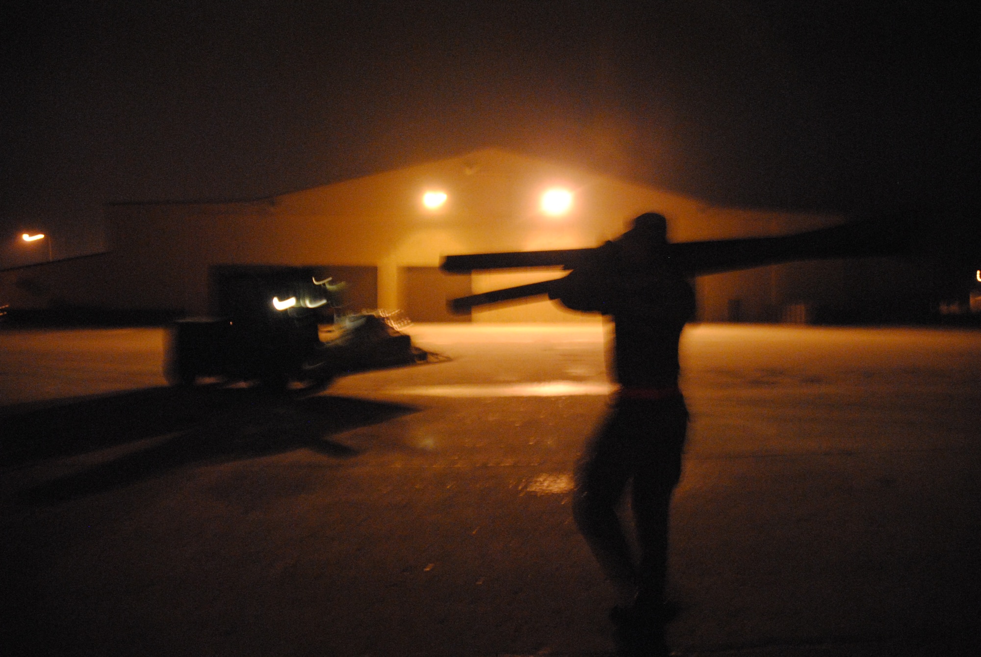 In cold, foggy weather, and hours before sunrise, vehicle operators from the 319th Logistics Readiness Squadron, Senior Airmen Paul Dell and Sean Wininger team up to get cargo palettes in place for the start of a deployment exercise on Grand Forks Air Force Base, N.D., Dec. 19, 2014. The 319th LRS was one of several units to participate during the exercise, which was designed to test Airmen’s response and skills in the case of a real world event. (U.S. Air Force photo/Staff Sgt. Luis Loza Gutierrez)