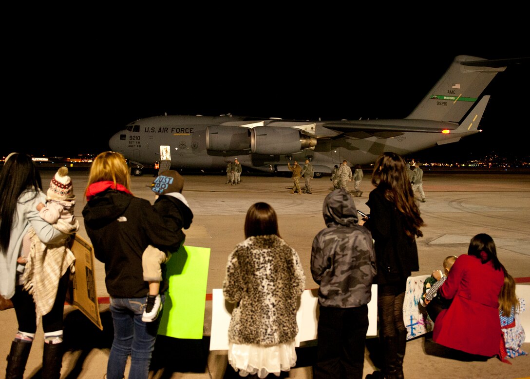 PETERSON AIR FORCE BASE, Colo. – Family members anxiously await the arrival of the 1st Expeditionary Space Control Squadron as it returned from southwest Asia Dec. 19, 2014. The squadron is a 21st Space Wing expeditionary unit that has been deployed in support of Operation Enduring Freedom since 2009 with the mission of providing space situational awareness and defensive space control operations in support of U.S. Central Command. The squadron’s operations provided around the clock protection to U.S. and allied satellite communication links. The homecoming marked the end of a successful five-year mission supported by more than 150 men and women of the 21st Space Wing, and was a testament to the vital role space operations play in providing global support to the warfighter. (U.S. Air Force photo by Airman 1st Class Rose Gudex)