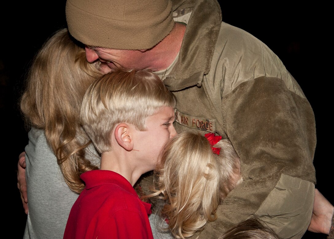 PETERSON AIR FORCE BASE, Colo. – The children of Tech. Sgt. Russel Lundy, 76th Space Control Squadron, shed a few tears as they welcome him back with the rest of the 1st Expeditionary Space Control Squadron, which returned from southwest Asia Dec. 19, 2014. The squadron is a 21st Space Wing expeditionary unit that has been deployed in support of Operation Enduring Freedom since 2009 with the mission of providing space situational awareness and defensive space control operations in support of U.S. Central Command. (U.S. Air Force photo by Airman 1st Class Rose Gudex)