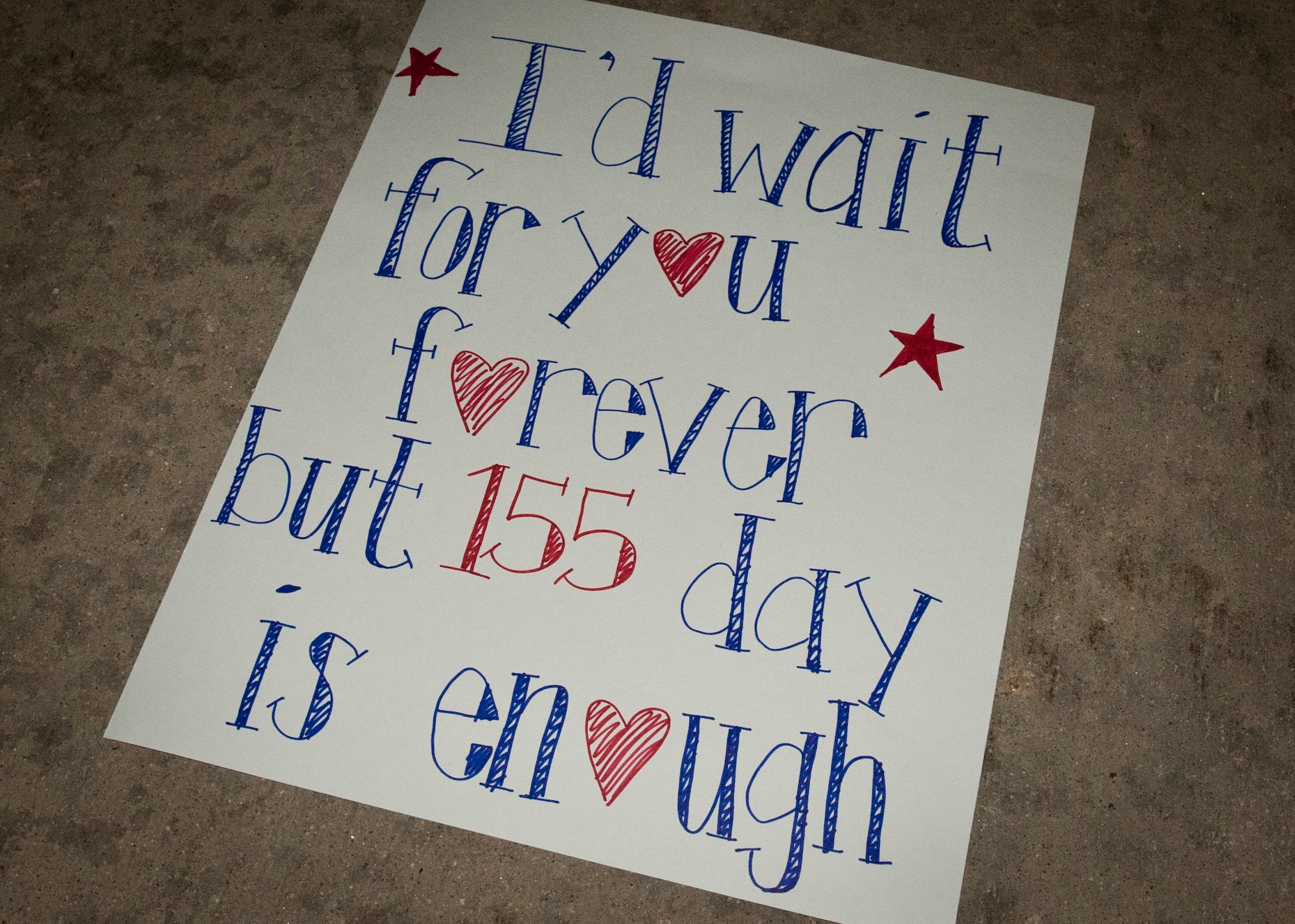 PETERSON AIR FORCE BASE, Colo. – One of the many signs held while waiting for a returning loved one lays discarded on the flightline while families are reunited as the 1st Expeditionary Space Control Squadron return from southwest Asia Dec. 19, 2014. The squadron is a 21st Space Wing expeditionary unit that has been deployed in support of Operation Enduring Freedom since 2009 with the mission of providing space situational awareness and defensive space control operations in support of U.S. Central Command. The squadron’s operations provided around the clock protection to U.S. and allied satellite communication links. The homecoming marked the end of a successful five-year mission supported by more than 150 men and women of the 21st Space Wing, and was a testament to the vital role space operations play in providing global support to the warfighter. (U.S. Air Force photo by Airman 1st Class Rose Gudex)