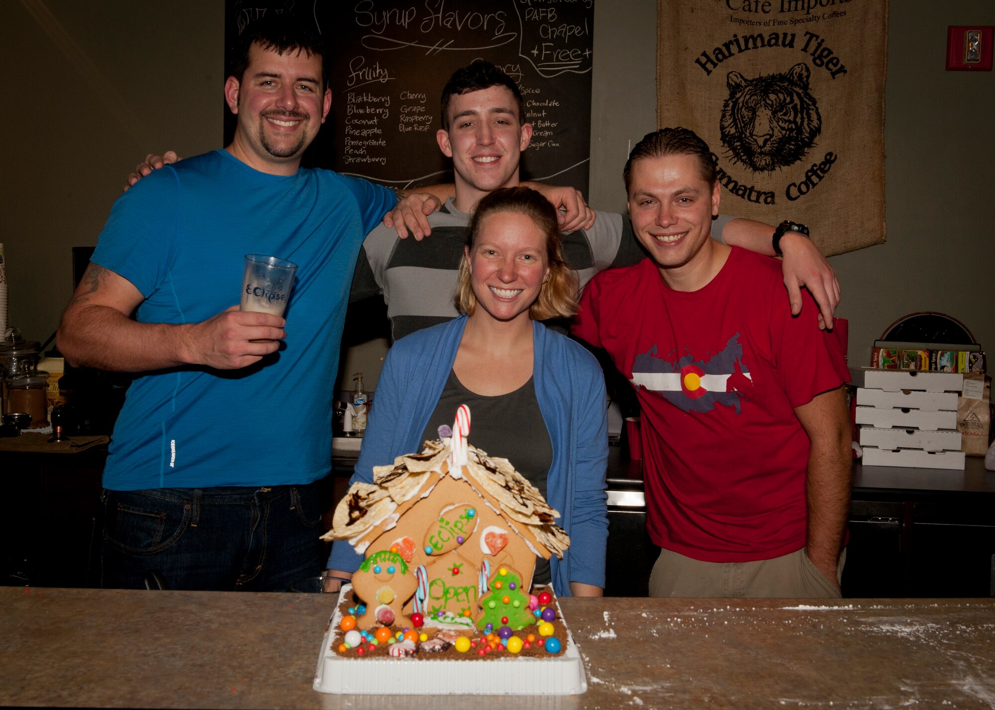 PETERSON AIR FORCE BASE, Colo. – The winning team, the Eclipse Café team, poses for a photo with their gingerbread house after beating seven other teams in the Chapel sponsored gingerbread house building contest at the Eclipse Café, Dec. 17, 2014. The team consisted of Eric Rodman, Eclipse Café barista; Michelle Cruz, Eclipse Café barista; Senior Airman Sergey Buettner, 50th Space Wing Security Forces Squadron; and Senior Airman Justin Cole, 2nd Space Operations Squadron satellite operator. (U.S. Air Force photo by Airman 1st Class Rose Gudex)