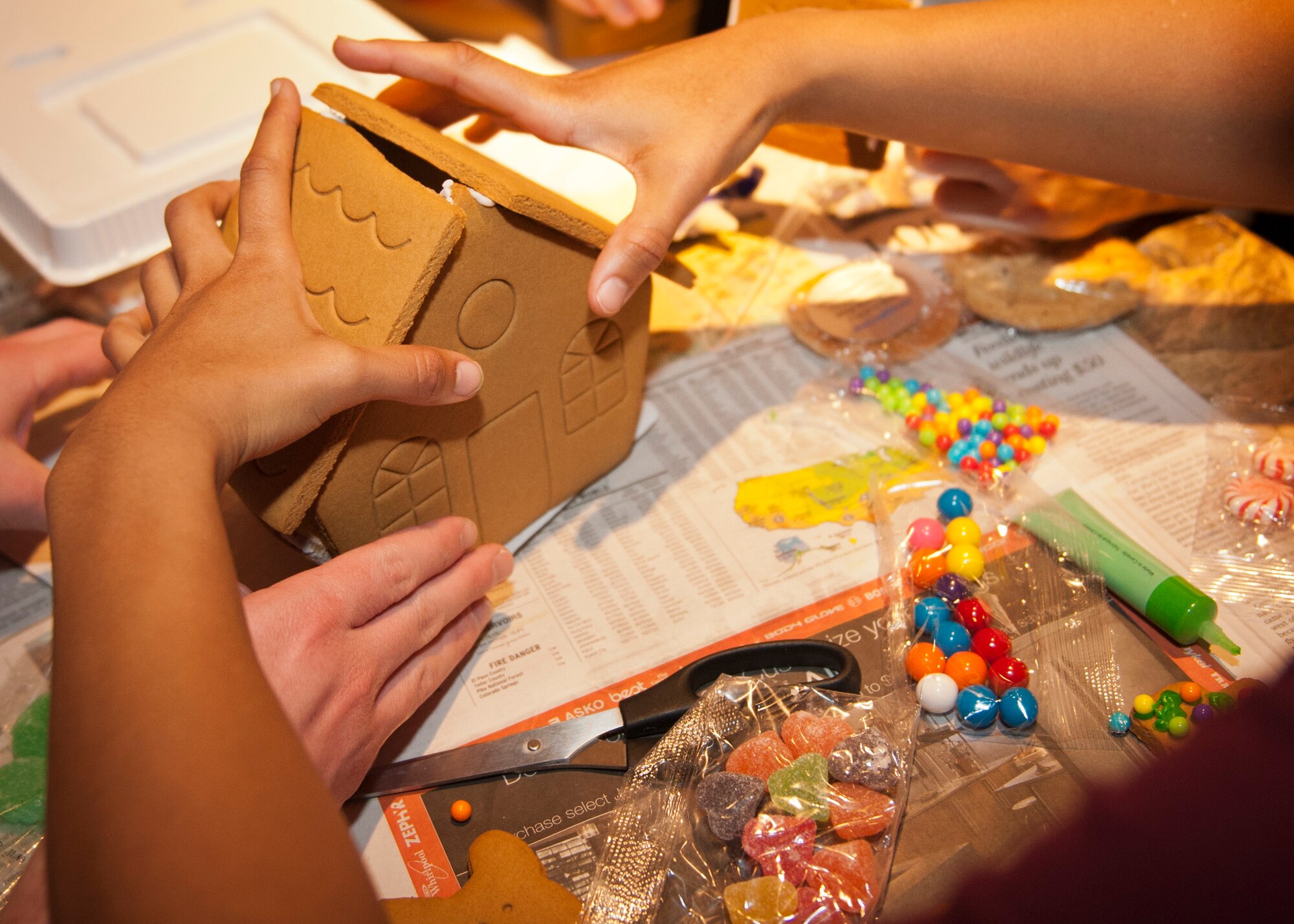 PETERSON AIR FORCE BASE, Colo. – Airman 1st Class Maricel DaCosta, 21st Communications Squadron, puts the pieces to the roof of her team’s gingerbread house at the Eclipse Café, Dec. 17, 2014. The gingerbread house building contest was another event the Chapel put on for Airmen to get together and have a good time. All the supplies, including food, drinks, gingerbread house supplies and prizes were all provided by the Chapel. (U.S. Air Force photo by Airman 1st Class Rose Gudex)