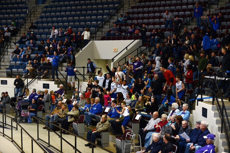 Team Dyess reaches for a prize Dec. 20, 2014, at Moody Coliseum in Abilene, Texas. Abilene Christian University hosted Dyess Air Force Base Day as the ACU Lady Wildcats basketball team went head-to-head against the U.S. Air Force Academy Lady Falcons. (U.S. Air Force photo by Airman 1st Class Kedesha Pennant/Released)