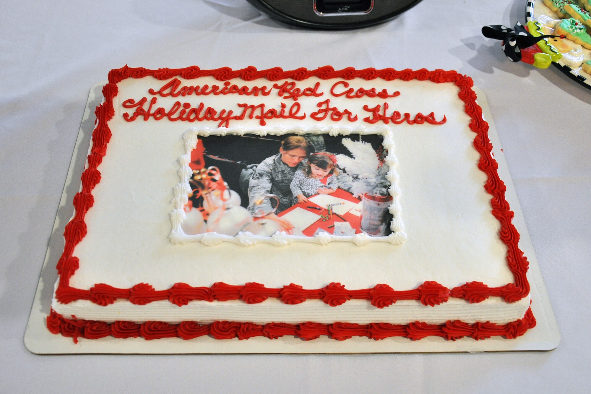 The “Holiday Mail for Heroes,” event was hosted by the 916th Air Refueling Wing and the American Red Cross, here for the third consecutive year. This cake from 2014 featured a photo of a 916th ARW Airmen and a family friend participating in last year’s holiday mail event. (U.S. Air Force photo/Staff Sgt. Alan Abernethy)