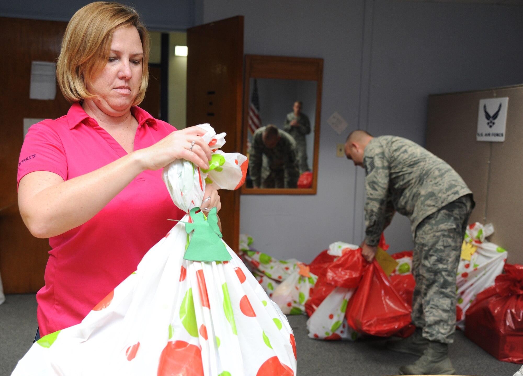 Master Sgts. Traci Devereaux, 85th Engineering Installation Squadron first sergeant, and Robert Kesler, 81st Force Support Squadron first sergeant,  package gifts that were donated through the Diamond Angel Tree program Dec. 23, 2014, at Bryan Hall, Keesler Air Force Base, Miss.  The Diamond Angel Tree is a program sponsored by the Keesler First Sergeant Council, with a goal to provide gifts for children of our Keesler families for the holiday season.  (U.S. Air Force photo by Kemberly Groue)