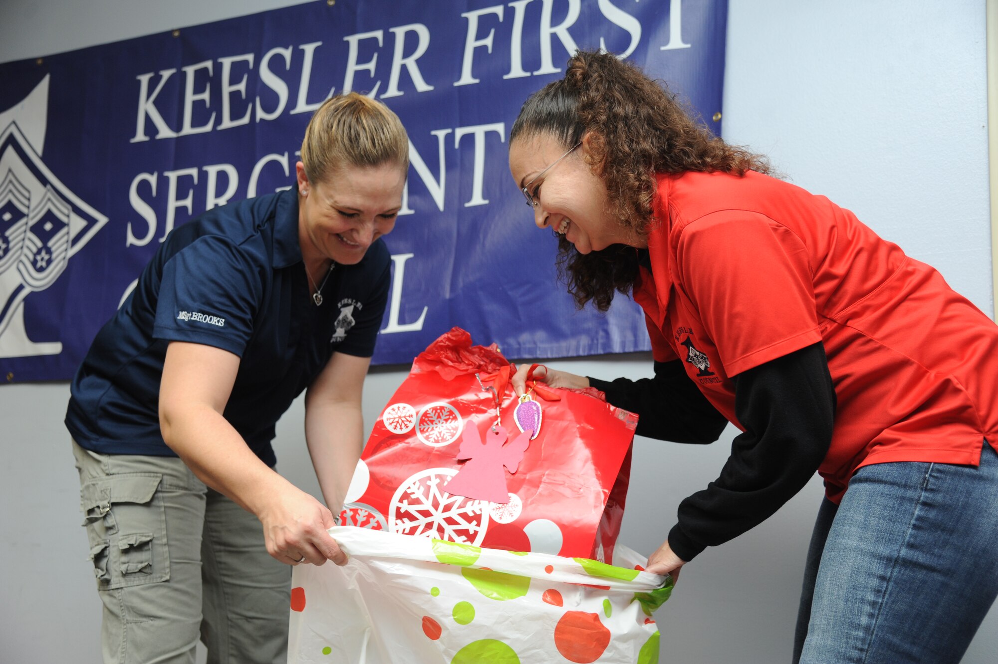 Master Sgts. Alissa Brooks, 81st Diagnostic and Therapeutics Squadron first sergeant, and Christina Tinsley, 336th Training Squadron first sergeant, package gifts that were donated through the Diamond Angel Tree program Dec. 23, 2014, at Bryan Hall, Keesler Air Force Base, Miss.  The Diamond Angel Tree is a program sponsored by the Keesler First Sergeant Council, with a goal to provide gifts for children of our Keesler families for the holiday season. (U.S. Air Force photo by Kemberly Groue)