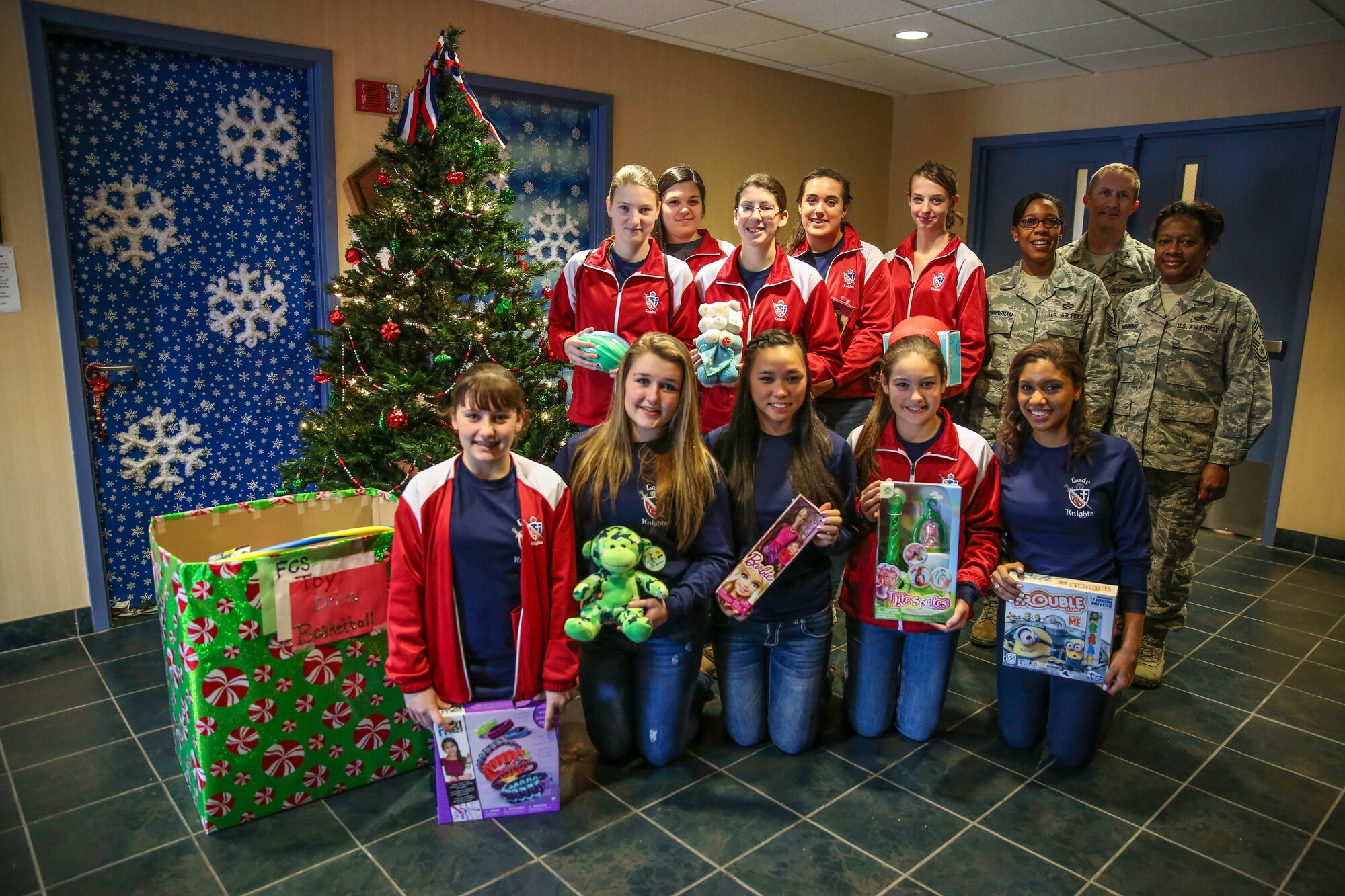 Members of the Summerville’s Faith Christian School girls basketball deliver more than 115 Christmas presents for Reserve families in need Dec. 19, 2014 at Joint Base Charleston, S.C. Master Sgt. Nichelle Cunningham, 315 AW Staff Judge Advocate Law Office superintendent and FCS girls basketball coach, helped organize the event as a mentoring opportunity for her young ladies – who went right to work and recruited the boys basketball team to help out with the toy drive.  Col. Jamie Fontanella, 315th AW commander, and Chief Master Sgt. Gigi Manning, 315th AW command chief master sergeant, greeted the young givers with warmth and gratitude, and they commended them for working so hard to collect all of the awesome gifts. (U.S. Air Force photo by Tech. Sgt. Shane Ellis)