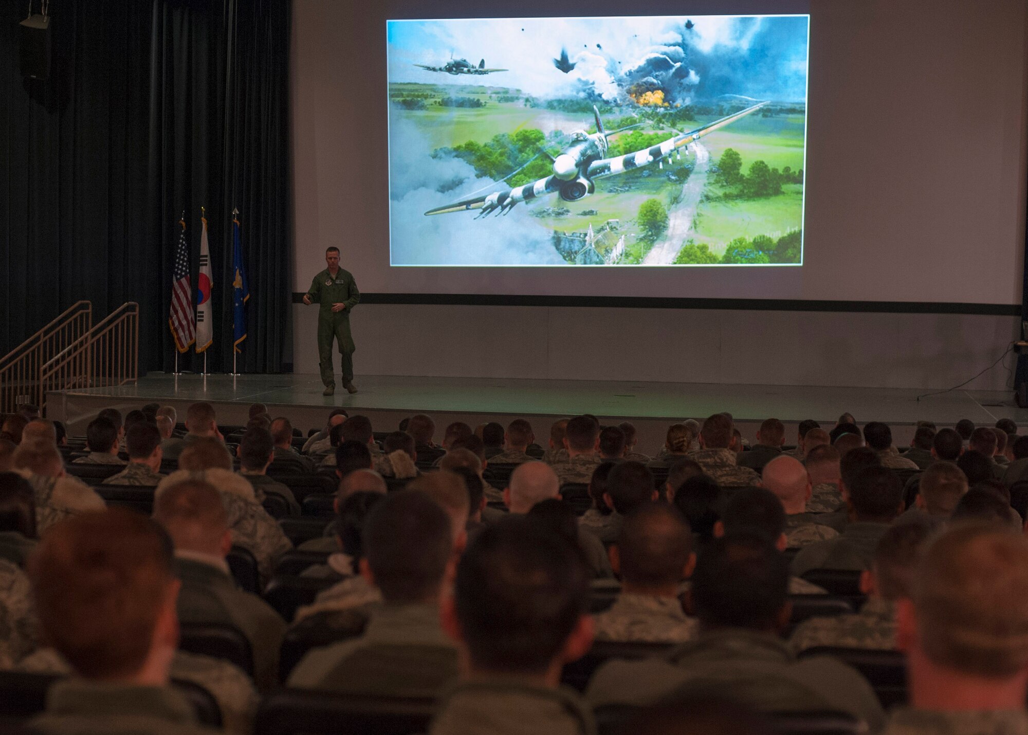 Col. Kenneth “Wolf” Ekman, 8th Fighter Wing commander addresses Wolf Pack Airmen in the base theater during a commander’s call at Kunsan Air Base, Republic of Korea, Dec. 24, 2014. Wolf stressed the importance of always having a wingman present when it comes to being on and off duty, especially during the holiday season. (U.S. Air Force photo by Senior Airman Taylor Curry/ Released) 