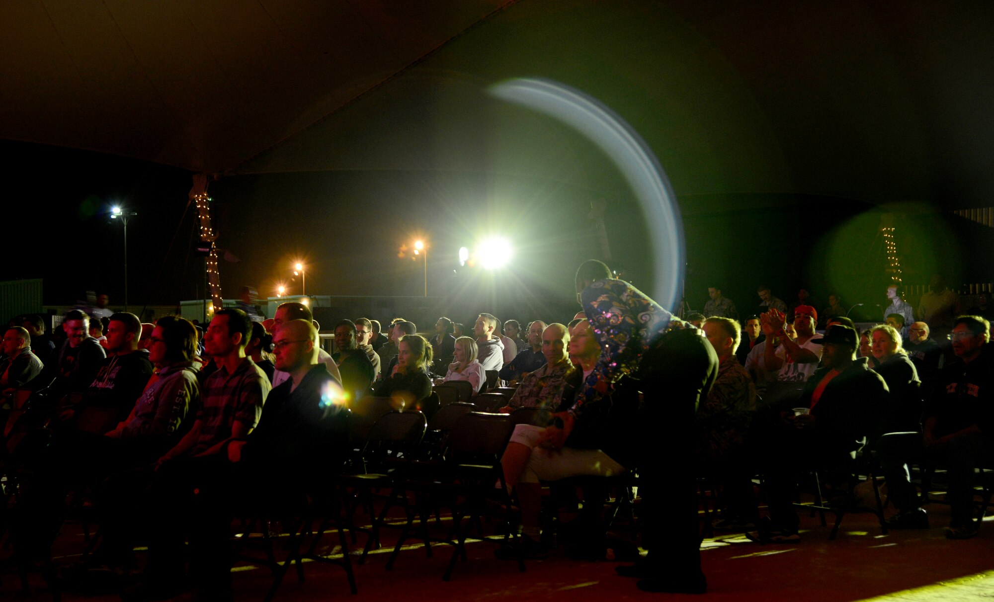 Team Al Udeid watch as Tops in Blue Airmen put on a performance, Dec. 23, 2014, at Al Udeid Air Base, Qatar. Tops in Blue visited Al Udeid as part of their 2014 world tour, which provides music, song and dance to audiences in more than 85 locations.  For 60 years, Tops in Blue has provided the military community and public with world-wide performances. (U.S. Air Force photo by Senior Airman Kia Atkins)