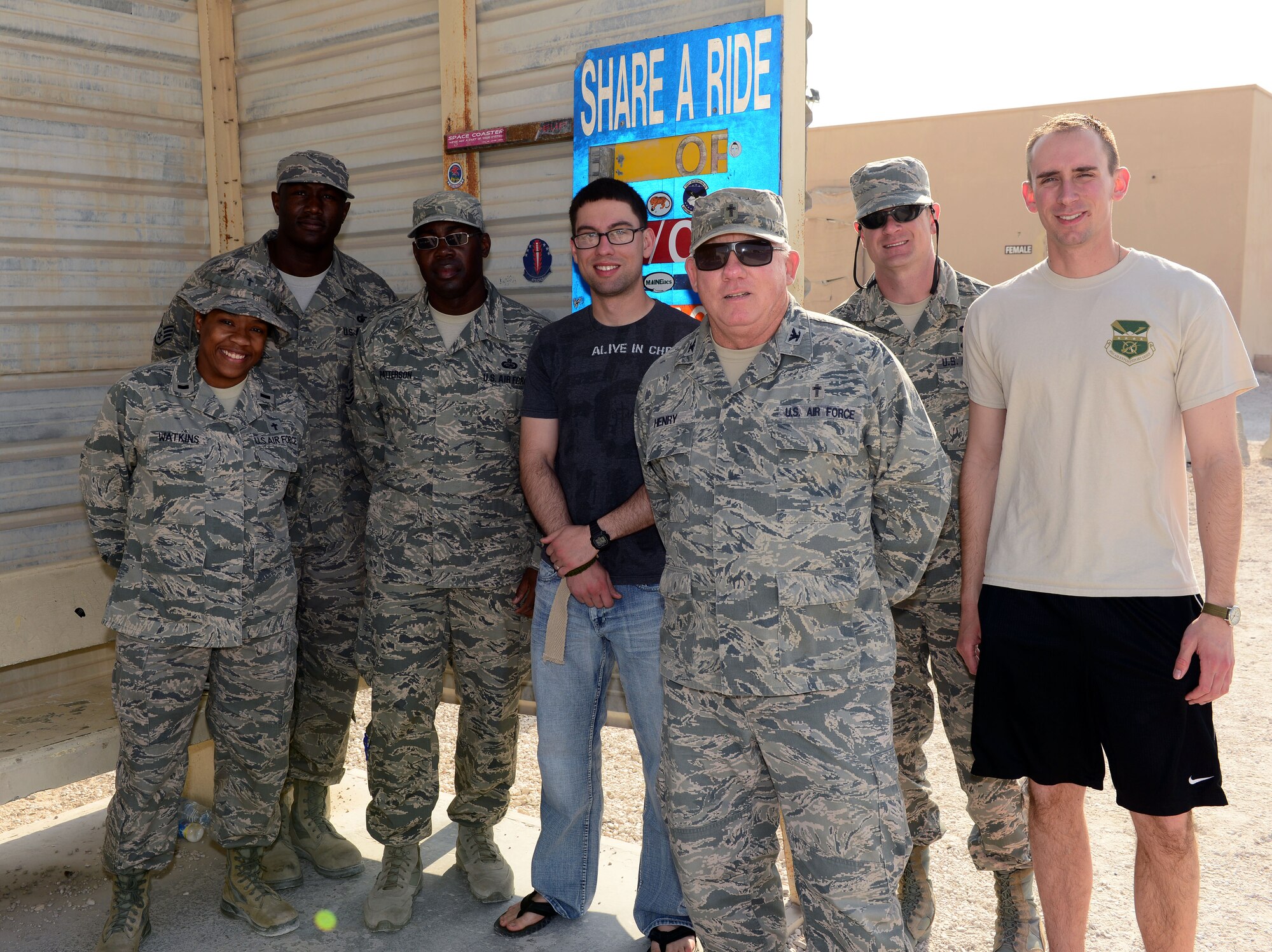 The 379th Air Expeditionary Wing Chaplain team makes their rounds on the base shuttle, December 23, 2014, to talk with U.S. servicemembers deployed to Al Udeid Air Base, Qatar, as part of Operation Build Up Spirituality. The operation is an all-out effort by the Al Udeid chapel team, first sergeants and military and family life counselors to increase resiliency for U.S. servicemembers deployed far away from home and from loved ones during the holiday season. (U.S. Air Force photo by Master Sgt. Kerry Jackson)