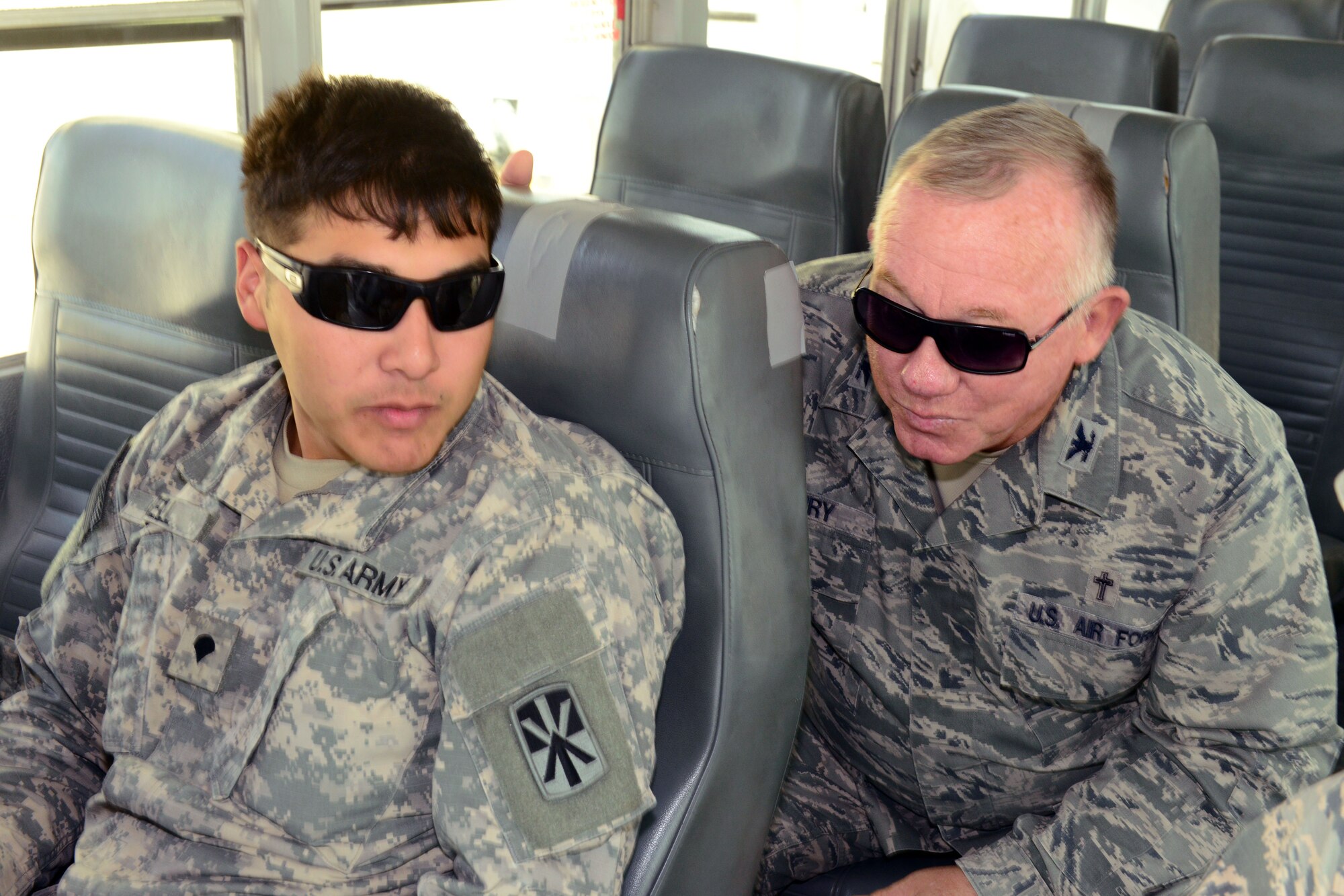 U.S. Air Force Col. Gerald Henry, 379th Air Expeditionary Wing chaplain (left), talks with Army Specialist Devin Snell, 11th Brigade, during his visit with U.S. servicemembers deployed to Al Udeid Air Base, Qatar, Dec. 23, 2014, as part of Operation Build Up Spirituality. The operation is an all-out effort by the Al Udeid chapel team, first sergeants and military and family life counselors to increase resiliency for U.S. servicemembers deployed far away from home and from loved ones during the holiday season. (U.S. Air Force photo by Master Sgt. Kerry Jackson)