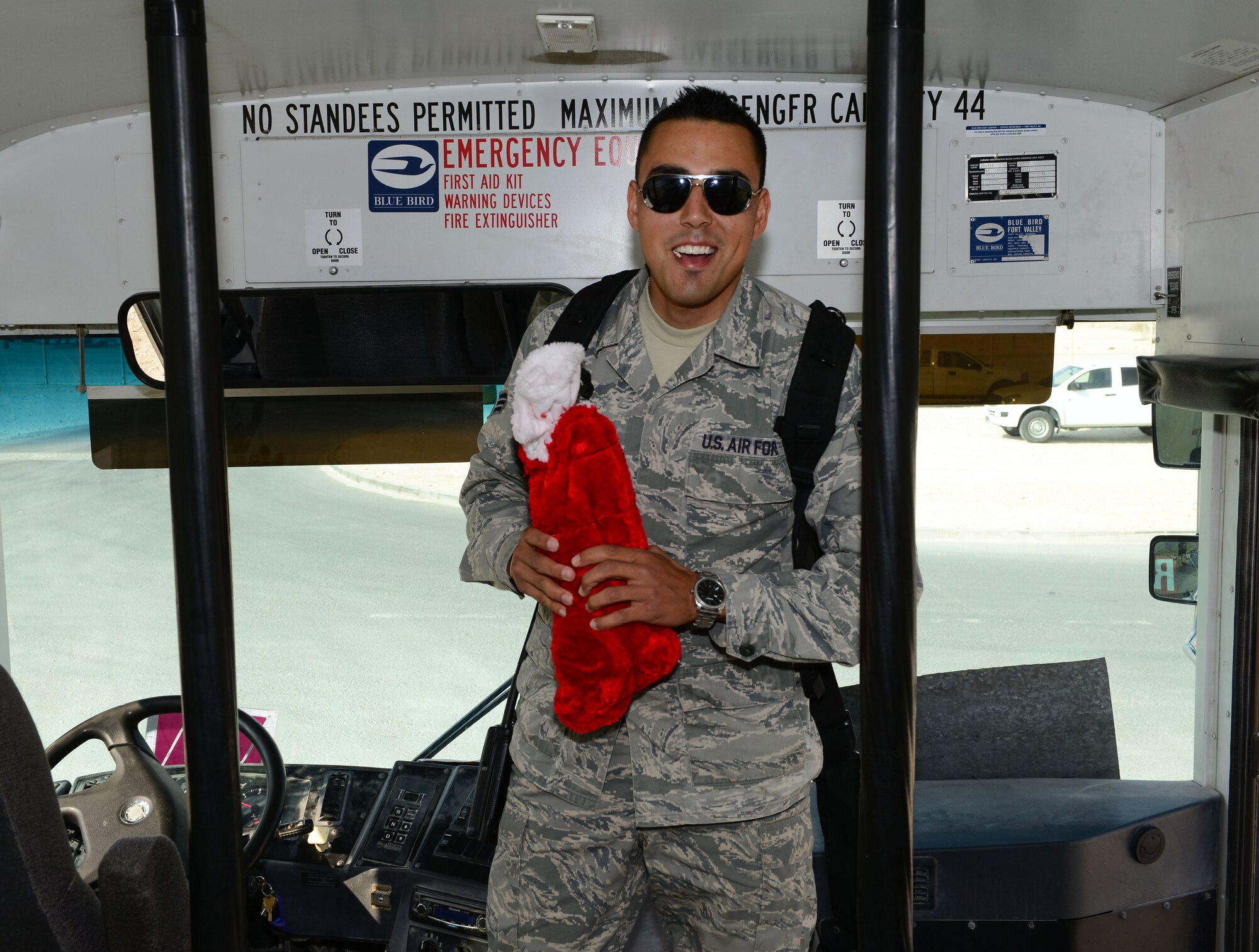 U.S. Air Force Senior Airman Marcus Bertelsen, 379th Expeditionary Logistics Readiness Squadron vehicle operator, receives a Christmas stocking from the 379th Air Expeditionary Wing chaplain team following his shift, Dec. 23, 2014, as part of Operation Build Up Spirituality. The operation is an all-out effort by the Al Udeid wing chapel team, first sergeants and military and family life counselors to increase resiliency for U.S. servicemembers deployed far away from home and from loved ones during the holiday season. Bertelsen is an Air Force Reservist deployed from Homestead Air Reserve Base, Fla. (U.S. Air Force photo by Master Sgt. Kerry Jackson)