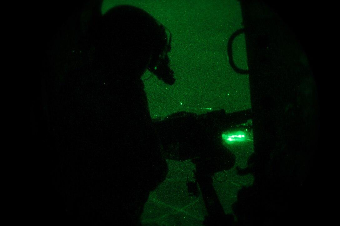 An Afghan air force Mi-17 gunner fires his M240B machine gun during the first night firing training mission, Nov 29, 2014 in Kabul, Afghanistan. This capability will allow the Afghan air force to take the fight to the enemy day and night. (U.S. Air Force photo by Staff Sgt. Perry Aston/Released)
