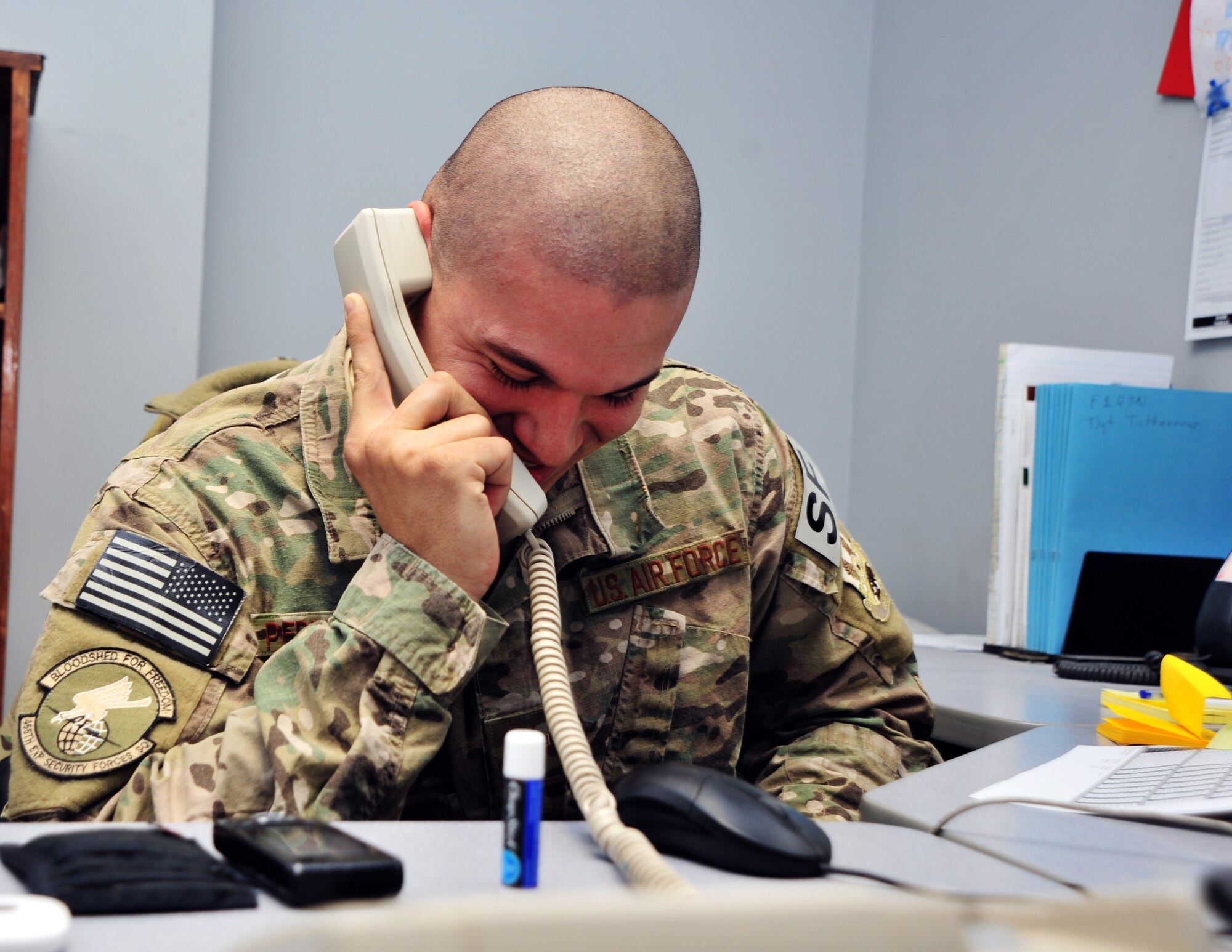 U.S. Air Force Airman 1st Class Frank Perez-Castillo, 455th Expeditionary Security Forces Squadron Commander Support Staff, talks to Chief Master Sgt. of the Air Force James A. Cody during a surprise phone call Dec. 24, 2014 at Bagram Airfield, Afghanistan. During the call, Cody expressed his well-wishes for the coming year and communicated his gratitude for Castillo-Perez’s service. (U.S. Air Force photo by Staff Sgt. Whitney Amstutz/released)
