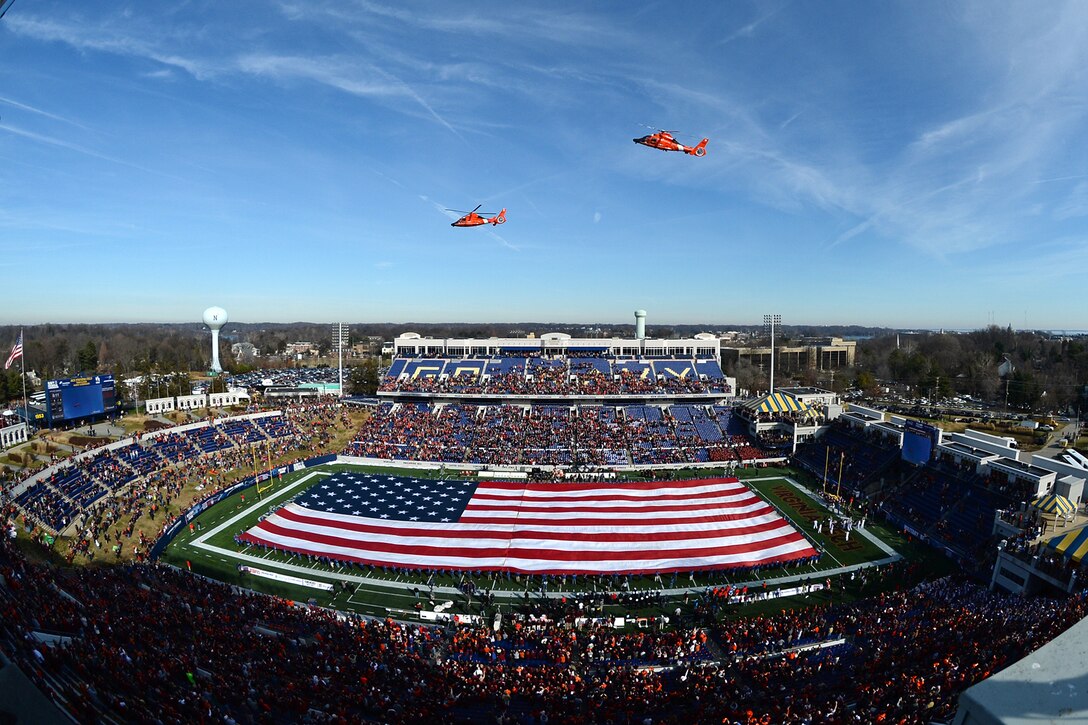 Coast Guard helicopters fly over Navy-Marine Corps Memorial Stadium at the start of the Military Bowl 2014 in Annapolis, Md,. Dec. 27, 2014. Virginia Tech beat Cincinnati 33-17. 