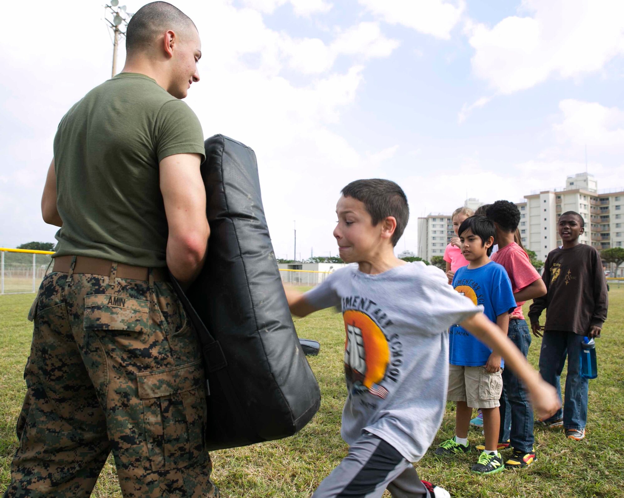 Cpl. Amin M. Amin teaches 4th graders of Kinser Elementary School Marine Corps Martial Arts Program techniques Dec. 10 during Warrior Day on Camp Kinser. Warrior Day teaches service member’s children more about what their parents do in the military on a regular basis. A series of stations were set up that involved using an AN/PRC-119F radio, a modified medical evacuation, setting up a two-man tent, and a modified combat fitness test. Amin is a metal worker with 3rd Maintenance Battalion, Combat Logistics Regiment 35, 3rd Marine Logistics Group, III Marine Expeditionary Force. 