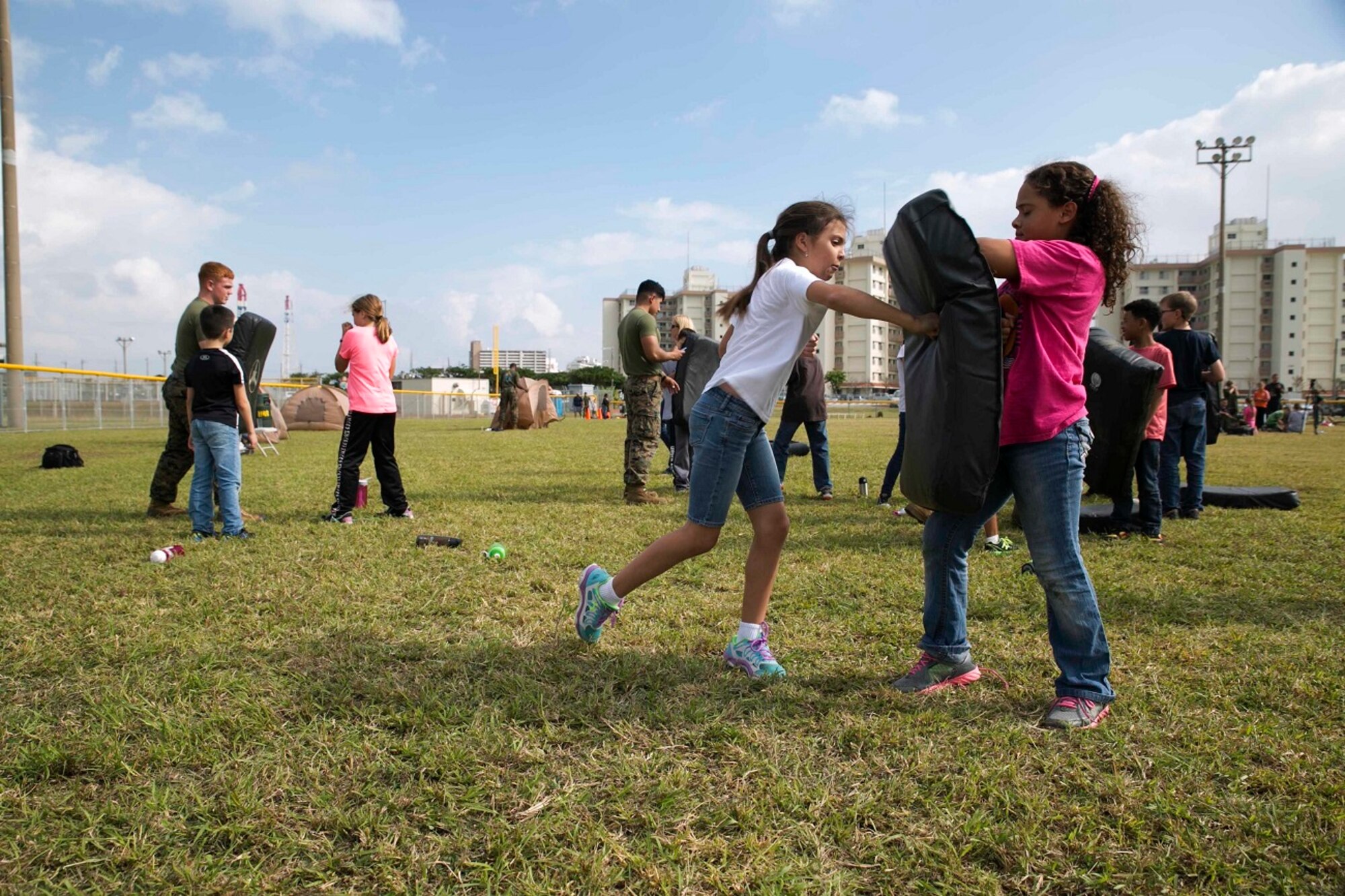 Kinser Elementary School 4th graders perform Marine Corps Martial Arts Program techniques Dec. 10 during Warrior Day on Camp Kinser. Warrior Day teaches service member’s children more about what their parents do in the military on a regular basis. A series of stations were set up that involved using an AN/PRC-119F radio, a modified medical evacuation, setting up a two-man tent, and a modified combat fitness test. 