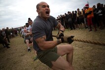 Master Chief Petty Officer Christopher Rebana screams cadence to unify his team’s pulling efforts during the “Christmas Tree Workout” as part of the Jingle Bell Challenge here Dec. 19. Rebana said events like this help to build camaraderie and “brings the sailors and Marines together.” Six battalions took part in the Jingle Bell Challenge, which consisted of several events, including a 5-kilometer run, interval exercise relay race, tug-of-war contest and Humvee pull. Rebana is a San Diego, Calif. native and command master chief of 3rd Medical Battalion, 3rd Marine Logistics Group, III Marine Expeditionary Force. (U.S. Marine Corps photo by Cpl. Matthew Callahan/Released)