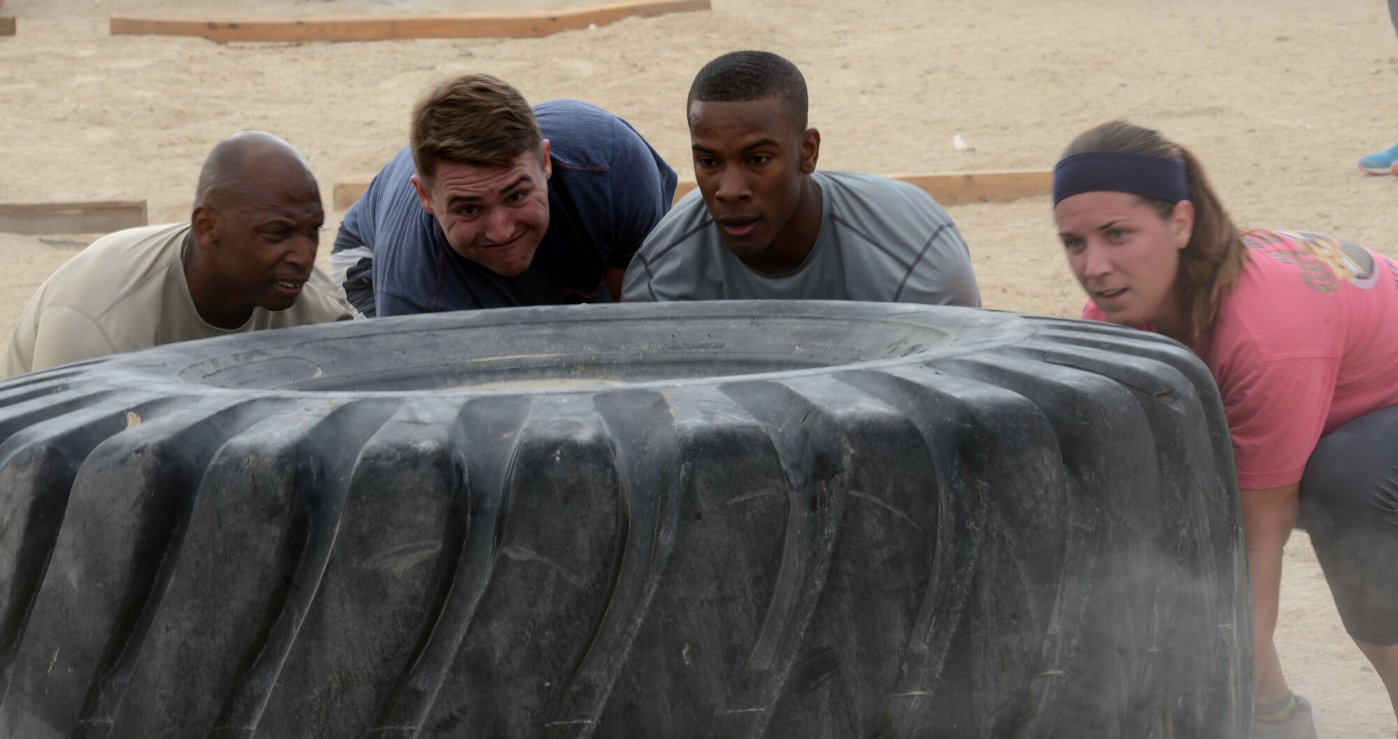 SOUTHWEST ASIA - Marauders flip a tire during the 386th Air Expeditionary Wing Warrior Challenge on Dec. 27, 2014. The course took approximately 48 hours to set up and included a 5K run and an obstacle course. (U.S. Air Force photo by Tech. Sgt. Jared Marquis/released)