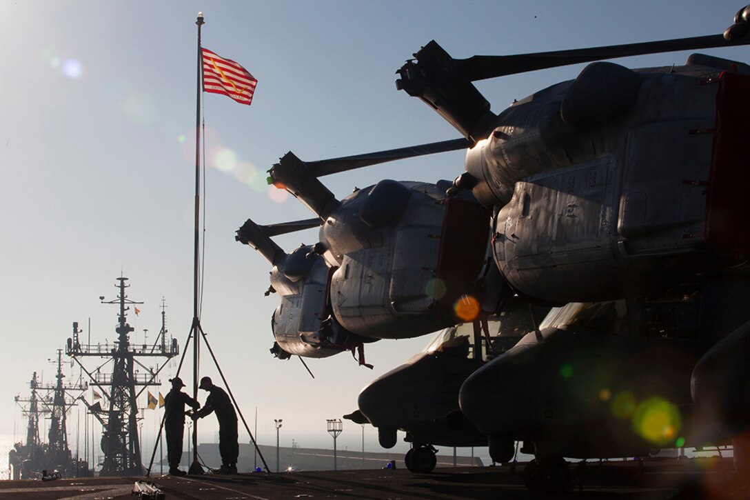 Sailors raise the ship’s colors as the USS Iwo Jima pulls into port at Naval Station Rota, Spain, Dec. 26, 2014. The 24th MEU and Iwo Jima Amphibious Ready Group are conducting naval operations in the U.S. 6th Fleet area of operations in support of U.S. national security interests in Europe. 