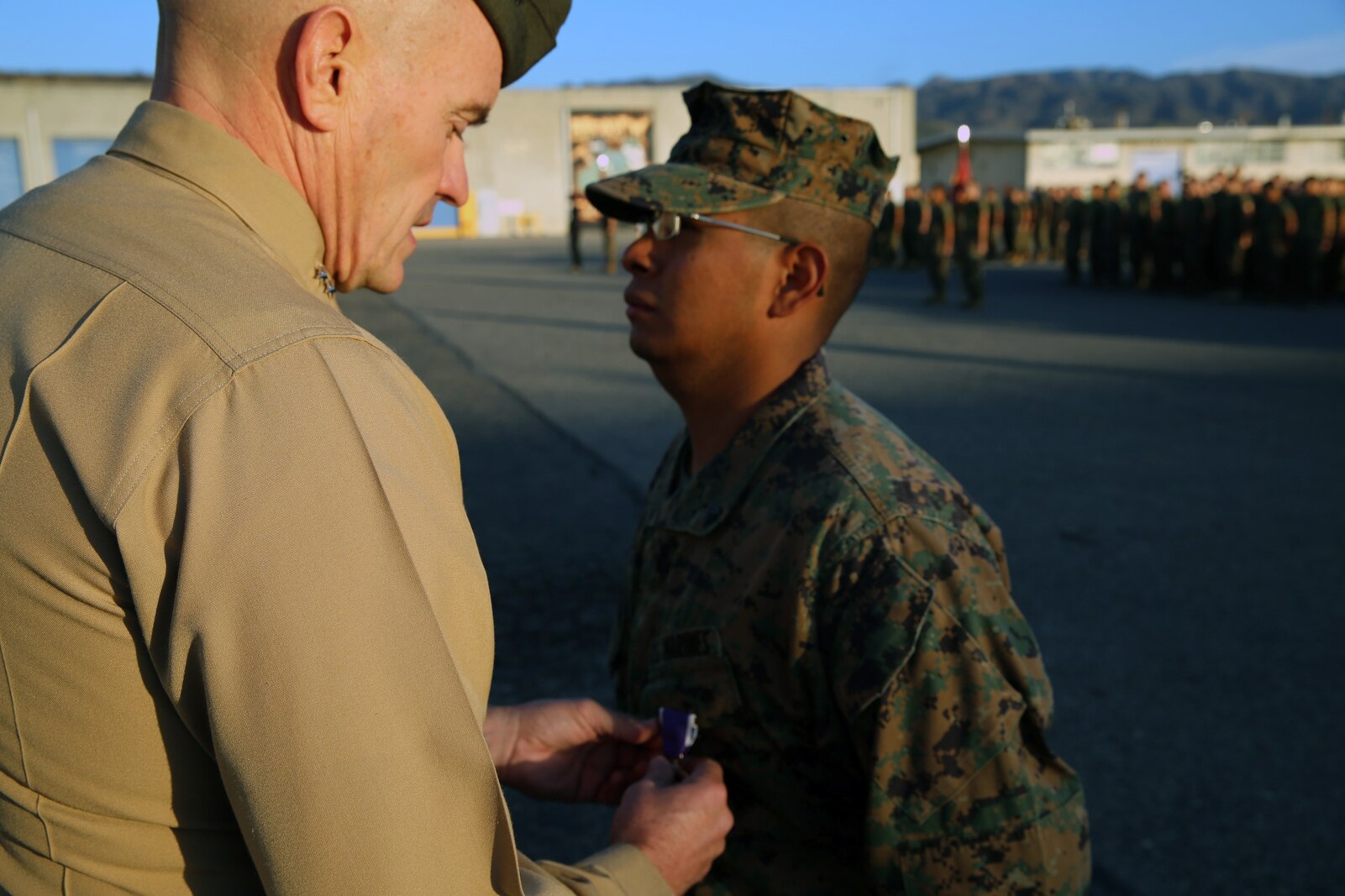 Corporal Ulises Zamoramartinez, an optics technician with 1st Maintenance Battalion, Combat Logistics Regiment 15, 1st Marine Logistics Group, recieves the Purple Heart Medal by Maj. Gen. Vincent Coglianese, commanding general 1st MLG, during an award ceremony aboard Camp Pendleton, California Dec. 19, 2014. Zamoramartinez, a 31-year-old native of Yakima, Washington, received the award for injuries received while deployed in Helmand province, Afghanistan during a six-month tour with Georgian Liaison Team 10, Regional Command (Southwest). (Marine Corps photo by Cpl. Cody Haas/ Released)