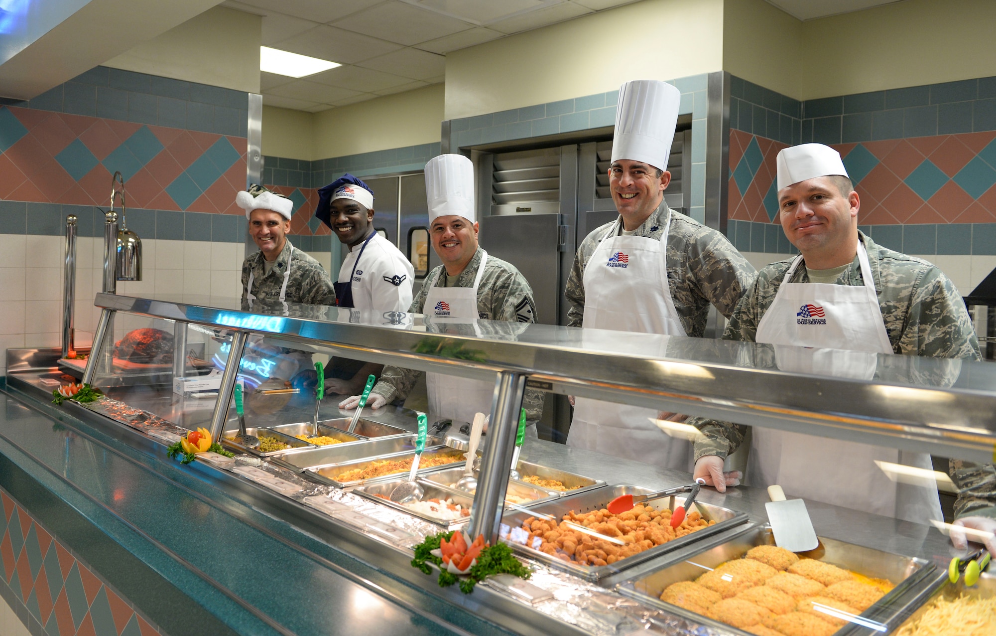 Hurlburt Field leadership pose for a photo while helping serve food at the Riptide Dining Facility during Christmas lunch on Hurlburt Field, Fla., Dec. 25, 2014. Leadership from the 1st Special Operations Wing served Air Commandos and retirees during the lunch. (U.S. Air Force photo/Senior Airman Meagan K. Schutter)