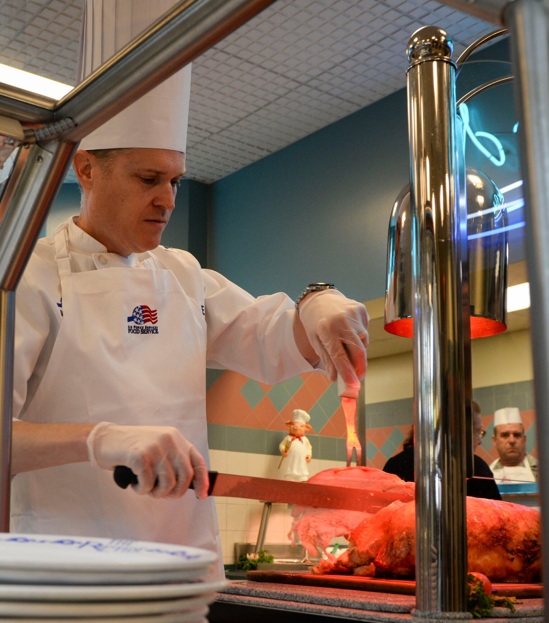 Col. Todd Fogle, 1st Special Operations Mission Support Group commander, carves a turkey for guests at the Riptide Dining Facility during Christmas lunch on Hurlburt Field, Fla., Dec. 25, 2014. Leadership from the 1st Special Operations Wing served Air Commandos and retirees during the lunch. (U.S. Air Force photo/ Senior Airman Meagan K. Schutter)