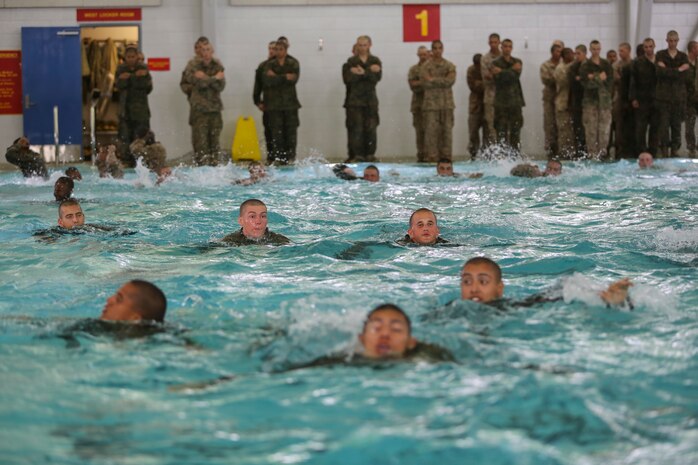 Recruits of Bravo Company, 1st Recruit Training Battalion, make their way across the pool during the a 25-meter swim portion of the Water Survival Basic Qualification at Marine Corps Recruit Depot San Diego, Dec. 15.  Recruits were instructed to not touch the bottom of the pool at any time during the swim or they would instantly fail and have to return for remedial training to try again.