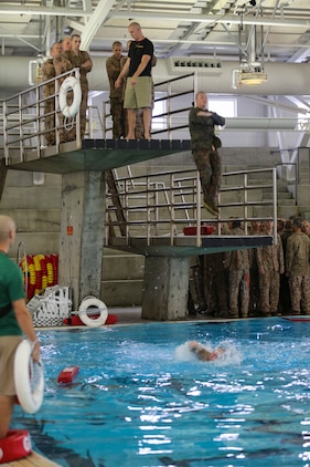 Recruits of Bravo Company, 1st Recruit Training Battalion, jump off a 10-foot platform during the Water Survival Basic Qualification at Marine Corps Recruit Depot San Diego, Dec. 15.  This event simulates having to jump off and abandon ship while out at sea