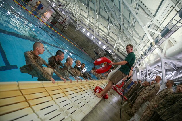 A Marine Corps Instructor of Water Survival gives advice to recruits of Bravo Company, 1st Recruit Training Battalion, before they begin their four-minute water tread during the Water Survival Basic Qualification at Marine Corps Recruit Depot San Diego, Dec. 15. Instructors teach recruits to stay calm and relax to make it through this event as it helps maintain buoyancy and reduce exhaustion.