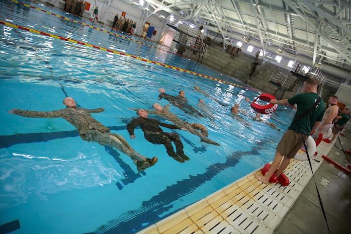 Recruits of Bravo Company, 1st Recruit Training Battalion, perform the four-minute water tread during the Water Survival Basic Qualification at Marine Corps Recruit Depot San Diego, Dec. 15.  Fear and lack of confidence caused some to become stressed and panicked, which made them forget the techniques they were taught.