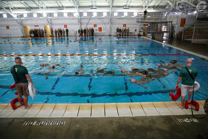Recruits of Bravo Company, 1st Recruit Training Battalion, perform the four-minute water tread during the Water Survival Basic Qualification at Marine Corps Recruit Depot San Diego, Dec. 15.  Fear and lack of confidence caused some to become stressed and panicked, which made them forget the techniques they were taught.
