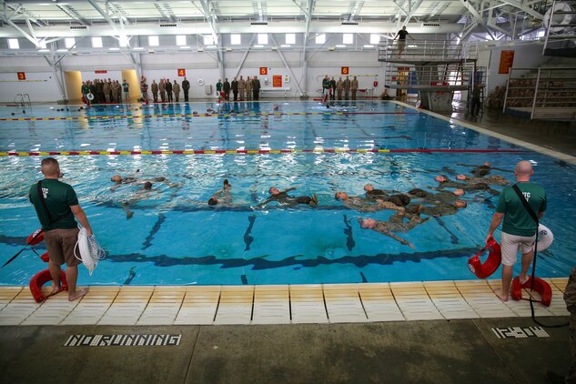 Recruits of Bravo Company, 1st Recruit Training Battalion, perform the four-minute water tread during the Water Survival Basic Qualification at Marine Corps Recruit Depot San Diego, Dec. 15.  Fear and lack of confidence caused some to become stressed and panicked, which made them forget the techniques they were taught.
