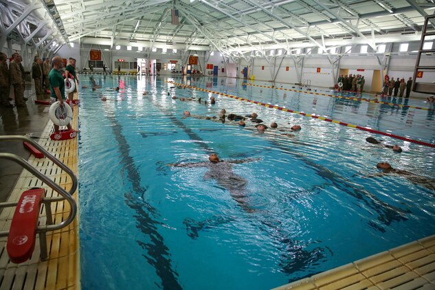 Recruits of Bravo Company, 1st Recruit Training Battalion, perform the four-minute water tread during the Water Survival Basic Qualification at Marine Corps Recruit Depot San Diego, Dec. 15.  Fear and lack of confidence caused some to become stressed and panicked, which made them forget the techniques they were taught.