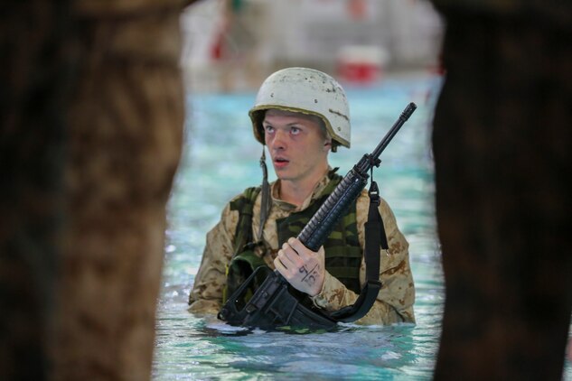 Recruit Joseph J. Birch, Platoon 1026, Bravo Company, 1st Recruit Training Battalion, prepares to perform the 10-second gear strip while submerged during the Water Survival Basic Qualification at Marine Corps Recruit Depot San Diego, Dec. 15.  This event helps train recruits to quickly strip heavy gear that may inhibit their ability to float while in deep water.