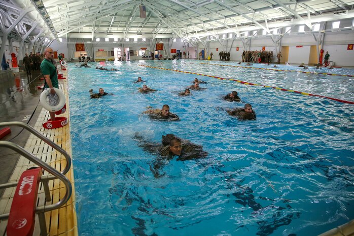 Recruits of Bravo Company, 1st Recruit Training Battalion, perform a 25-meter swim using a waterproof pack during the Water Survival Basic Qualification at Marine Corps Recruit Depot San Diego, Dec. 15.  Although the majority of recruit training is focused on land-based training, combat water survival training is just as critical to learn. 