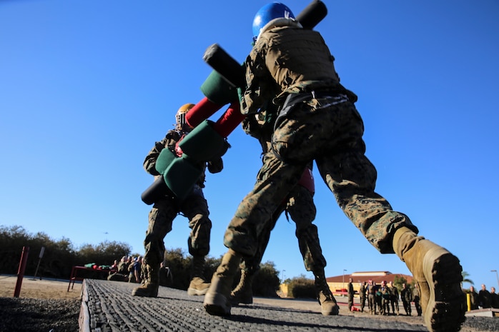 Recruits of Lima Company, 3rd Recruit Training Battalion, fight each other during a pugil stick bout at Marine Corps Recruit San Diego, Dec. 4. Once in the arena, the fighters were checked by the Marine Corps Martial Arts Instructor or a drill instructor to ensure their gear was properly worn before their bout began.