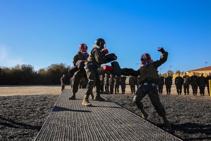 Recruits of Lima Company, 3rd Recruit Training Battalion, fight each other during a pugil stick bout at Marine Corps Recruit San Diego, Dec. 4. Before the battles began, recruits donned their protective gear because once in the arena, they used full force. Helmets, groin protector, flak jackets, gloves and mouthpieces were given to each recruit. 