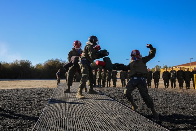 Recruits of Lima Company, 3rd Recruit Training Battalion, fight each other during a pugil stick bout at Marine Corps Recruit San Diego, Dec. 4. Before the battles began, recruits donned their protective gear because once in the arena, they used full force. Helmets, groin protector, flak jackets, gloves and mouthpieces were given to each recruit. 